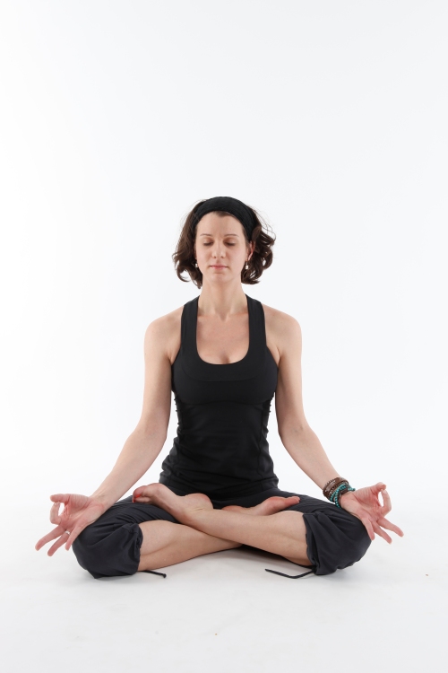 A woman sits in lotus position